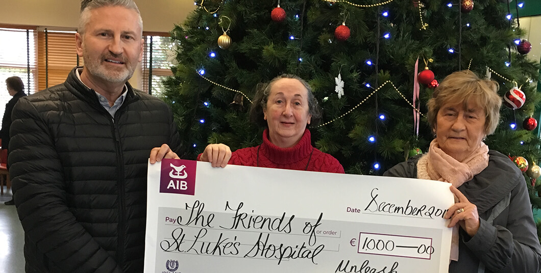 Maurice giving a cheque to St Luke's
